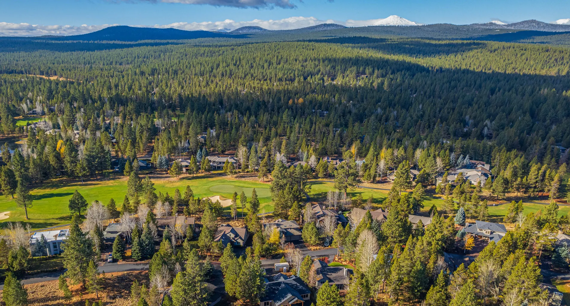 Aerial view of a Central Oregon neighborhood surrounded by pines, roofed by Spey Roofing